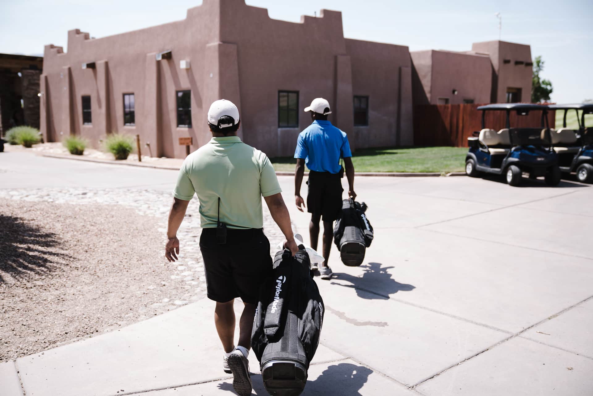A golfer walking a fairway carrying a bag